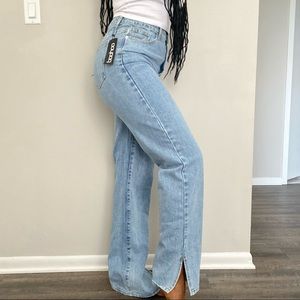 Light wash straight leg blue jeans with ankle slits